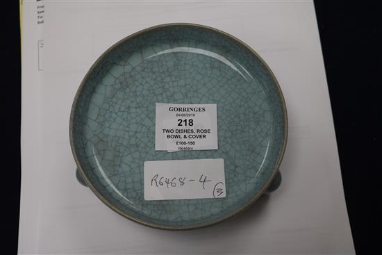 A Chinese celadon glazed dish, a Jun type tripod dish and a famille rose bowl and cover